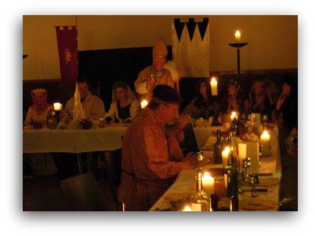 bishop raises a toast at medieval feast